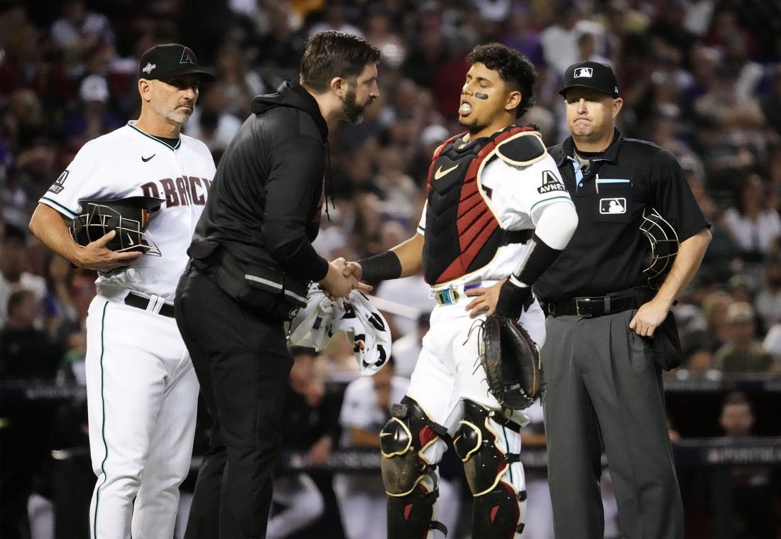 Oct 11, 2023; Phoenix, AZ, USA; Arizona Diamondbacks catcher Gabriel Moreno (14) reacts to an injury against the Los Angeles Dodgers in the fifth inning during Game 3 of the NLDS at Chase Field. Mandatory Credit: Rob Schumacher-Arizona Republic