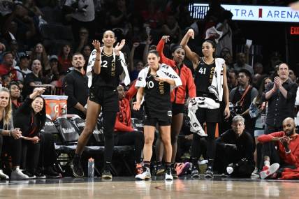 Oct 11, 2023; Las Vegas, Nevada, USA; Las Vegas Aces forward A'ja Wilson (22), guard Kelsey Plum (10), guard Jackie Young (0) and center Kiah Stokes (41) react to a play against the New York Liberty during the second half during game two of the 2023 WNBA Finals at Michelob Ultra Arena. Mandatory Credit: Candice Ward-USA TODAY Sports