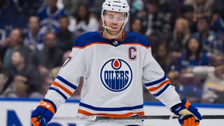 Oct 11, 2023; Vancouver, British Columbia, CAN; Edmonton Oilers forward Connor McDavid (97) reacts to the a goal being scored against the Vancouver Canucks in the second period at Rogers Arena. Mandatory Credit: Bob Frid-USA TODAY Sports