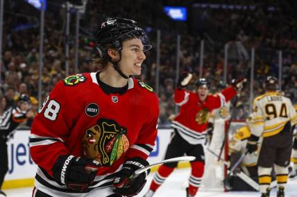 Oct 11, 2023; Boston, Massachusetts, USA; Chicago Blackhawks center Connor Bedard (98) smiles after scoring his first NHL goal during the first period against the Boston Bruins at TD Garden. Mandatory Credit: Winslow Townson-USA TODAY Sports