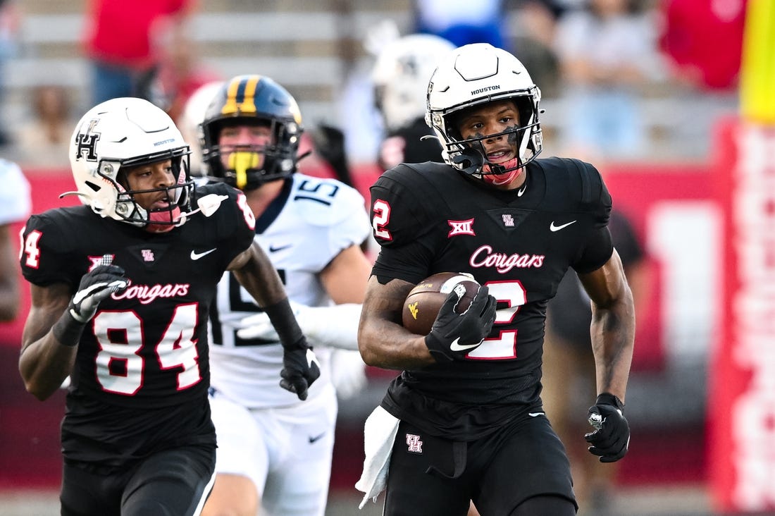 Oct 12, 2023; Houston, Texas, USA; Houston Cougars wide receiver Matthew Golden (2) runs the ball back for a touchdown on a kick off during the first quarter against the West Virginia Mountaineers  at TDECU Stadium. Mandatory Credit: Maria Lysaker-USA TODAY Sports