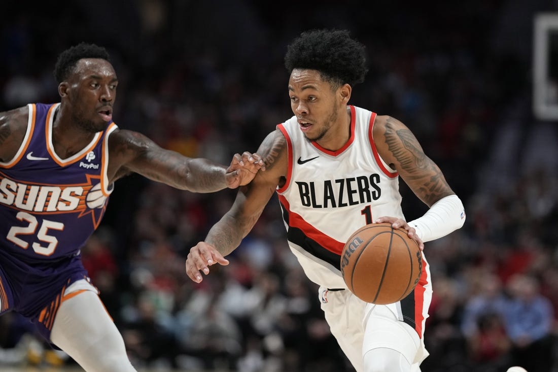 Oct 12, 2023; Portland, Oregon, USA; Portland Trail Blazers shooting guard Anfernee Simons (1) dribbles the ball while defended by Phoenix Suns small forward Nassir Little (25) during the first half at Moda Center. Mandatory Credit: Soobum Im-USA TODAY Sports
