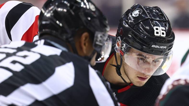 Oct 13, 2023; Newark, New Jersey, USA; New Jersey Devils center Jack Hughes (86) gets ready to face-off against the Arizona Coyotes during the second period at Prudential Center. Mandatory Credit: Ed Mulholland-USA TODAY Sports