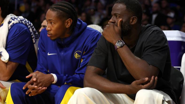 Oct 13, 2023; Los Angeles, California, USA;  Golden State Warriors Draymond Green (right) watches a game against the Los Angeles Lakers at Crypto.com Arena. Mandatory Credit: Kiyoshi Mio-USA TODAY Sports