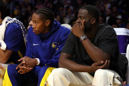Oct 13, 2023; Los Angeles, California, USA;  Golden State Warriors Draymond Green (right) watches a game against the Los Angeles Lakers at Crypto.com Arena. Mandatory Credit: Kiyoshi Mio-USA TODAY Sports