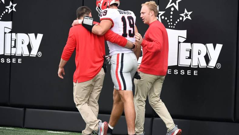 Oct 14, 2023; Nashville, Tennessee, USA; Georgia Bulldogs tight end Brock Bowers (19) walks off the field after an injury during the first half against the Vanderbilt Commodores at FirstBank Stadium. Mandatory Credit: Christopher Hanewinckel-USA TODAY Sports