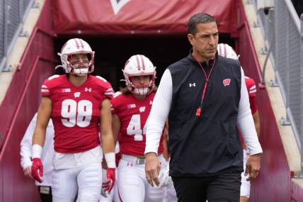Oct 14, 2023; Madison, Wisconsin, USA;  Wisconsin Badgers coach Luke Fickell leads the football team onto the field for warmups prior to the game against the Iowa Hawkeyes at Camp Randall Stadium. Mandatory Credit: Jeff Hanisch-USA TODAY Sports