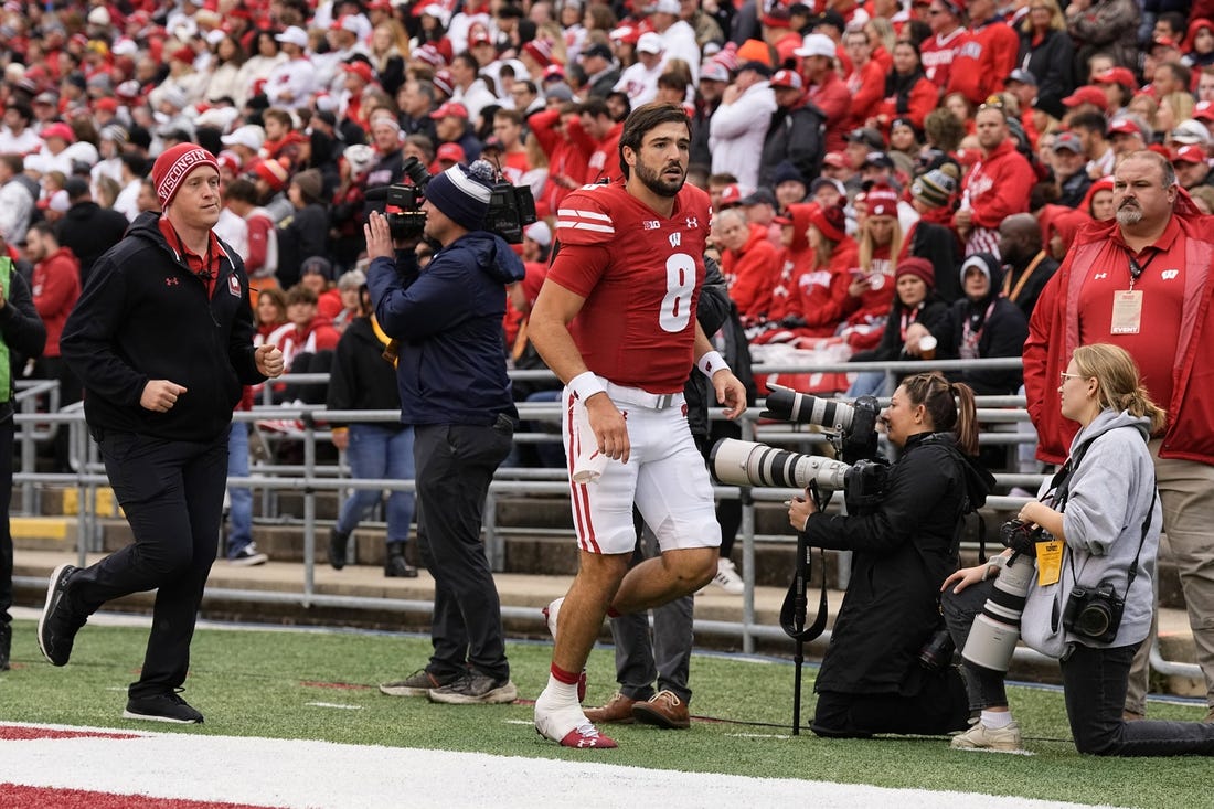 Oct 14, 2023; Madison, Wisconsin, USA;  Wisconsin Badgers quarterback Tanner Mordecai (8) runs to the locker room during the second quarter against the Iowa Hawkeyes at Camp Randall Stadium. Mandatory Credit: Jeff Hanisch-USA TODAY Sports