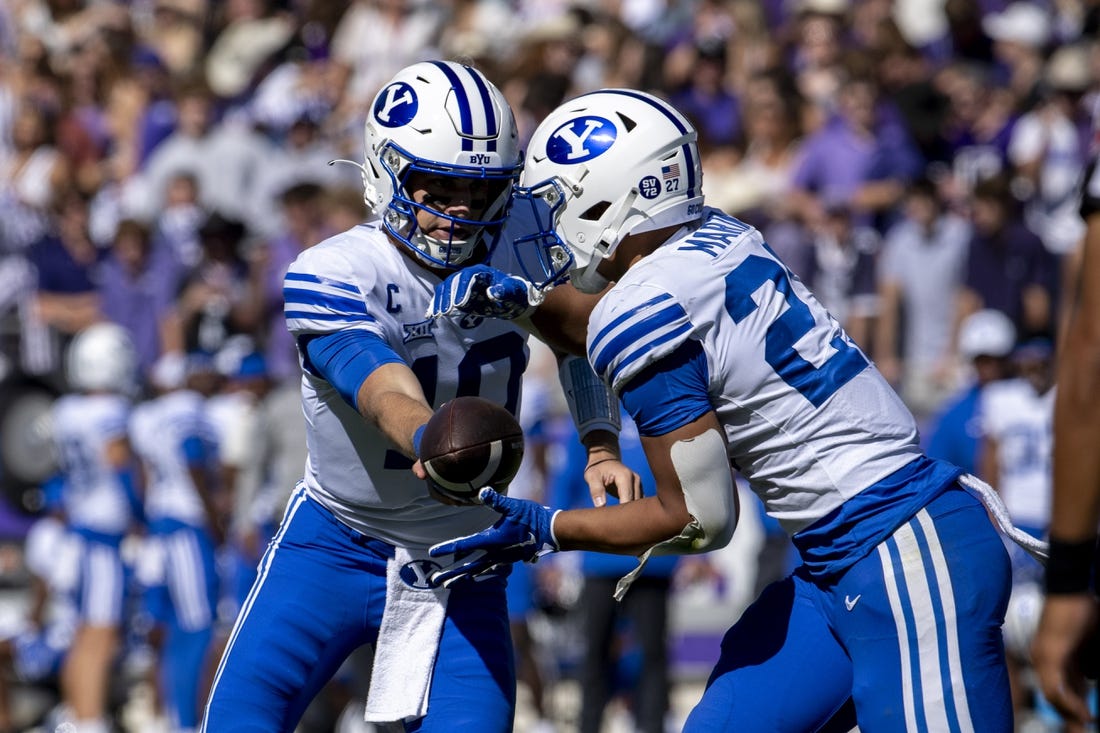 Oct 14, 2023; Fort Worth, Texas, USA; Brigham Young Cougars quarterback Kedon Slovis (10) hands the ball off to running back LJ Martin (27) during the game at Amon G. Carter Stadium. Mandatory Credit: Jerome Miron-USA TODAY Sports