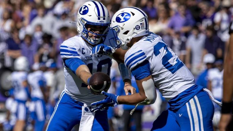 Oct 14, 2023; Fort Worth, Texas, USA; Brigham Young Cougars quarterback Kedon Slovis (10) hands the ball off to running back LJ Martin (27) during the game at Amon G. Carter Stadium. Mandatory Credit: Jerome Miron-USA TODAY Sports