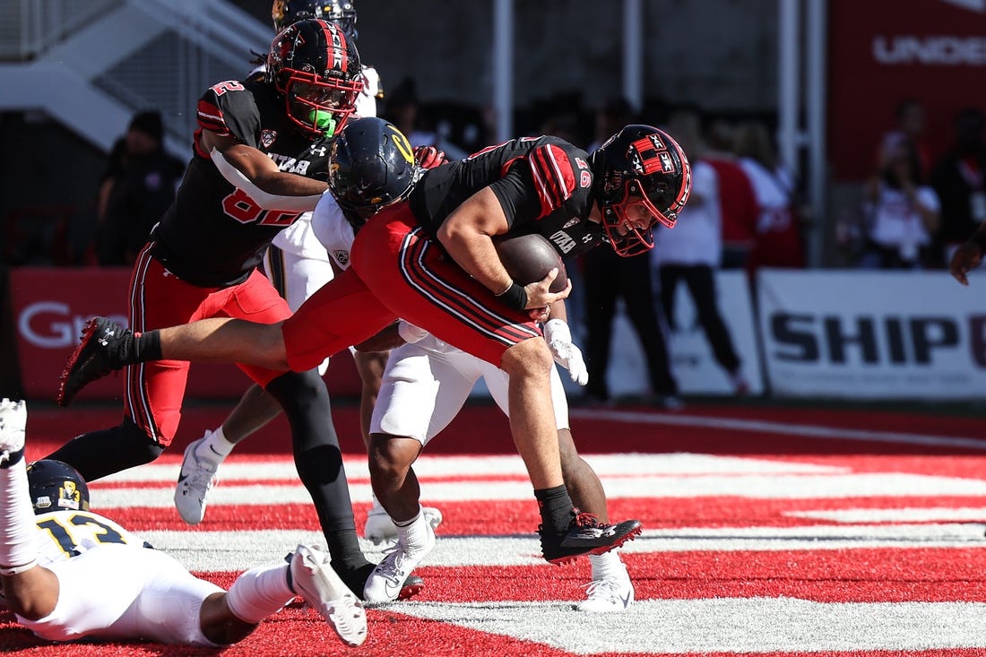 Oct 14, 2023; Salt Lake City, Utah, USA; Utah Utes quarterback Bryson Barnes (16) runs in for a touchdown against the California Golden Bears in the second half at Rice-Eccles Stadium. Mandatory Credit: Rob Gray-USA TODAY Sports