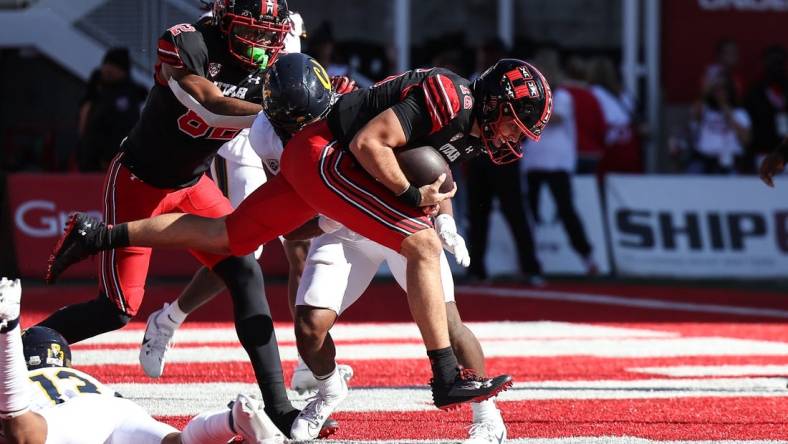 Oct 14, 2023; Salt Lake City, Utah, USA; Utah Utes quarterback Bryson Barnes (16) runs in for a touchdown against the California Golden Bears in the second half at Rice-Eccles Stadium. Mandatory Credit: Rob Gray-USA TODAY Sports