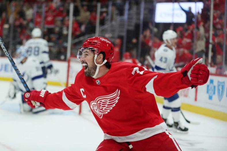 Oct 14, 2023; Detroit, Michigan, USA;  Detroit Red Wings center Dylan Larkin celebrates a goal by right wing Alex DeBrincat against Tampa Bay Lightning goaltender Jonas Johansson during first-period action on Saturday, Oct. 14, 2023, in Detroit, Michigan. Mandatory Credit: Kirthmon F. Dozier-USA TODAY Sports