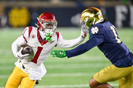 Oct 14, 2023; South Bend, Indiana, USA; USC Trojans wide receiver Zachariah Branch (1) carries as Notre Dame Fighting Irish safety Ramon Henderson (11) defends in the first quarter at Notre Dame Stadium. Mandatory Credit: Matt Cashore-USA TODAY Sports