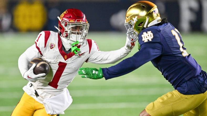 Oct 14, 2023; South Bend, Indiana, USA; USC Trojans wide receiver Zachariah Branch (1) carries as Notre Dame Fighting Irish safety Ramon Henderson (11) defends in the first quarter at Notre Dame Stadium. Mandatory Credit: Matt Cashore-USA TODAY Sports