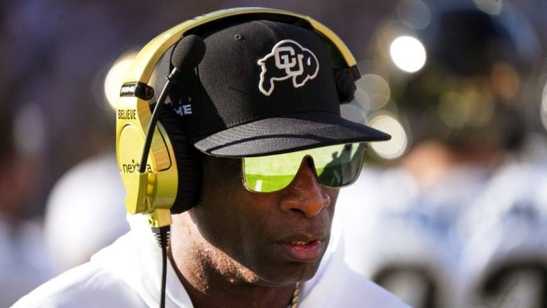 Deion Sanders walks the sidelines as the Colorado plays Arizona State at Mountain America Stadium.