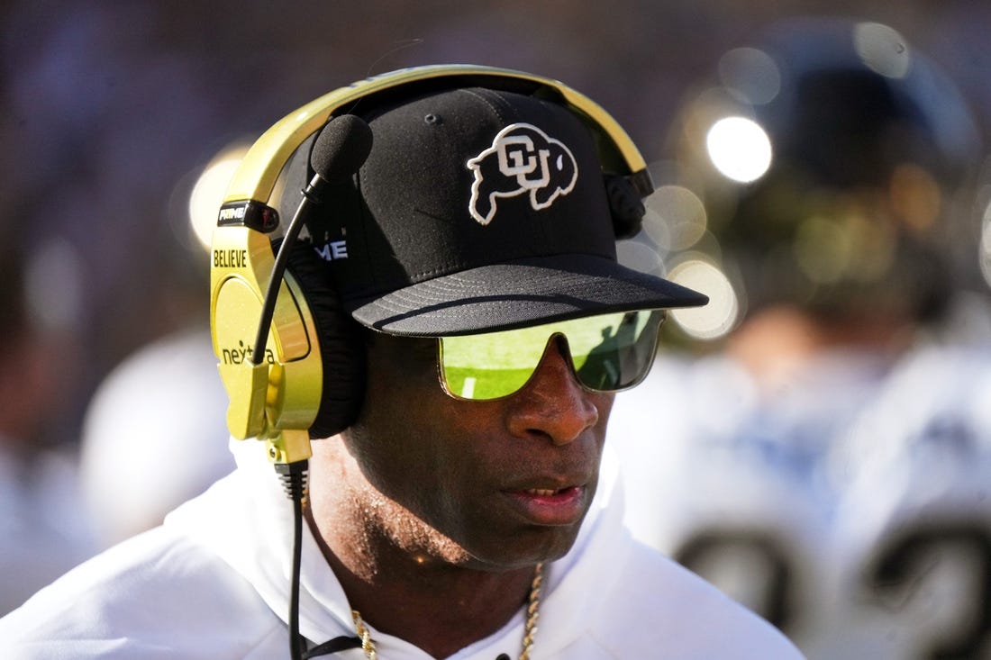 Deion Sanders walks the sidelines as the Colorado plays Arizona State at Mountain America Stadium.