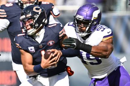 Oct 15, 2023; Chicago, Illinois, USA;  Chicago Bears quarterback Justin Fields (1) is chased out of the pocket by Minnesota Vikings linebacker Danielle Hunter (99) in the first half at Soldier Field. Mandatory Credit: Jamie Sabau-USA TODAY Sports