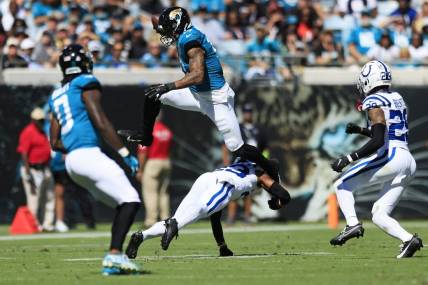 Jacksonville Jaguars tight end Evan Engram (17) hurdles Indianapolis Colts cornerback Kenny Moore II (23) during the second quarter of an NFL football matchup Sunday, Oct. 15, 2023 at EverBank Stadium in Jacksonville, Fla. [Corey Perrine/Florida Times-Union]
