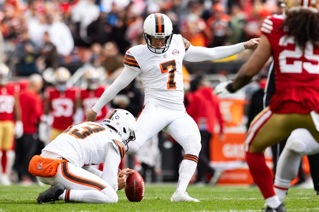 Oct 15, 2023; Cleveland, Ohio, USA; Cleveland Browns punter Corey Bojorquez (13) holds the ball for place kicker Dustin Hopkins (7) as he kicks a point after against the San Francisco 49ers during the second quarter try at Cleveland Browns Stadium. Mandatory Credit: Scott Galvin-USA TODAY Sports