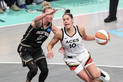 Oct 15, 2023; Brooklyn, New York, USA; Las Vegas Aces guard Kelsey Plum (10) drives around New York Liberty guard Courtney Vandersloot (22) in the first quarter during game three of the 2023 WNBA Finals at Barclays Center. Mandatory Credit: Wendell Cruz-USA TODAY Sports