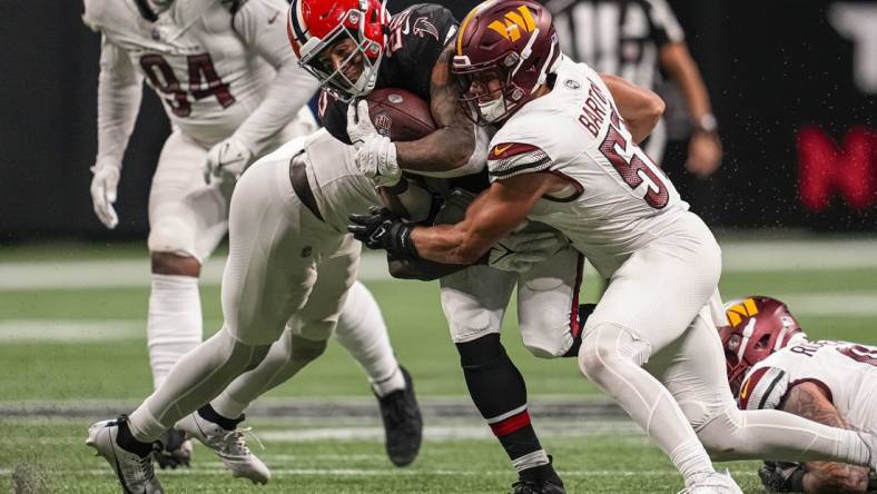 Oct 15, 2023; Atlanta, Georgia, USA; Atlanta Falcons running back Tyler Allgeier (25) is tackled by Washington Commanders linebacker Cody Barton (57) during the second half at Mercedes-Benz Stadium. Mandatory Credit: Dale Zanine-USA TODAY Sports