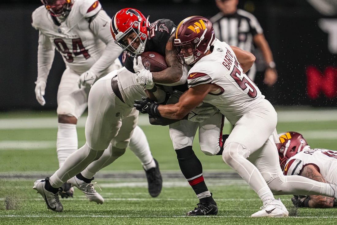 Oct 15, 2023; Atlanta, Georgia, USA; Atlanta Falcons running back Tyler Allgeier (25) is tackled by Washington Commanders linebacker Cody Barton (57) during the second half at Mercedes-Benz Stadium. Mandatory Credit: Dale Zanine-USA TODAY Sports