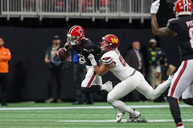 Oct 15, 2023; Atlanta, Georgia, USA; Atlanta Falcons quarterback Desmond Ridder (9) is tackled by Washington Commanders defensive end Casey Toohill (95) in the second half at Mercedes-Benz Stadium. Mandatory Credit: Brett Davis-USA TODAY Sports