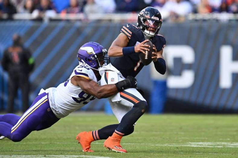Oct 15, 2023; Chicago, Illinois, USA;  Chicago Bears quarterback Justin Fields (1) is sacked by Minnesota Vikings linebacker Danielle Hunter (99) in the second half at Soldier Field. Mandatory Credit: Jamie Sabau-USA TODAY Sports