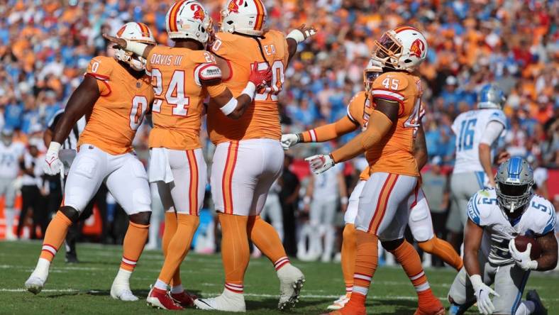 Oct 15, 2023; Tampa, Florida, USA; Tampa Bay Buccaneers defensive tackle Vita Vea (50) reacts after he tackles Detroit Lions running back David Montgomery (5) during the first quarter at Raymond James Stadium. Mandatory Credit: Kim Klement Neitzel-USA TODAY Sports