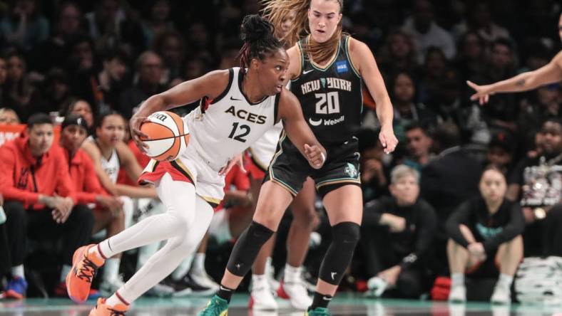 Oct 15, 2023; Brooklyn, New York, USA; Las Vegas Aces guard Chelsea Gray (12) drives around New York Liberty guard Sabrina Ionescu (20) in the third quarter during game three of the 2023 WNBA Finals at Barclays Center. Mandatory Credit: Wendell Cruz-USA TODAY Sports