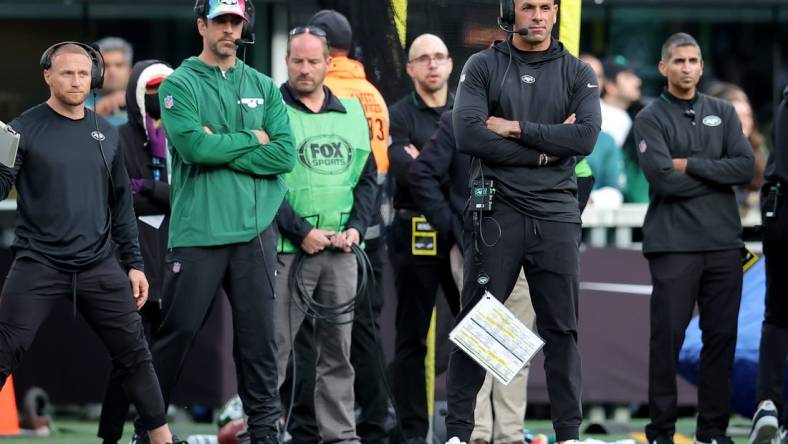 Oct 15, 2023; East Rutherford, New Jersey, USA; New York Jets injured quarterback Aaron Rodgers (left) and head coach Robert Saleh on the sidelines during the first quarter against the Philadelphia Eagles at MetLife Stadium. Mandatory Credit: Brad Penner-USA TODAY Sports