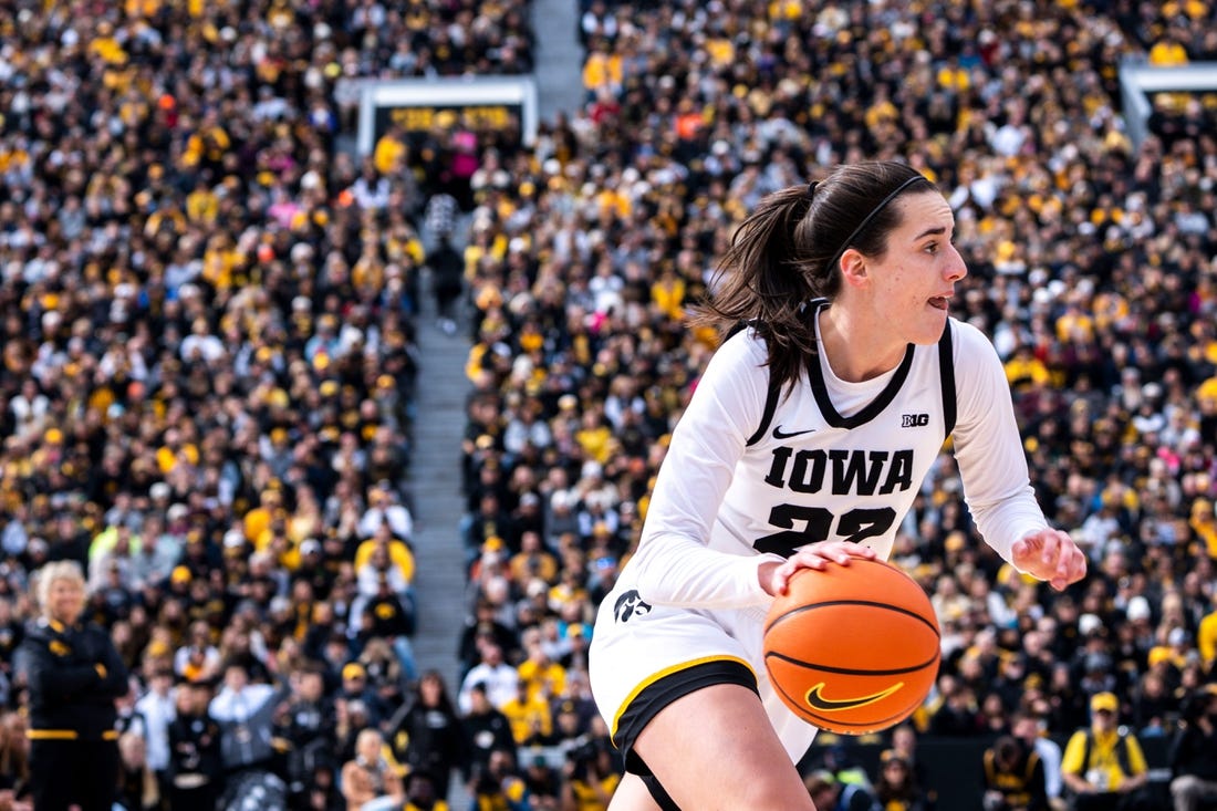 Iowa guard Caitlin Clark (22) drives to the basket during Crossover at Kinnick at Kinnick Stadium on Sunday, October 15, 2023 in Iowa City.