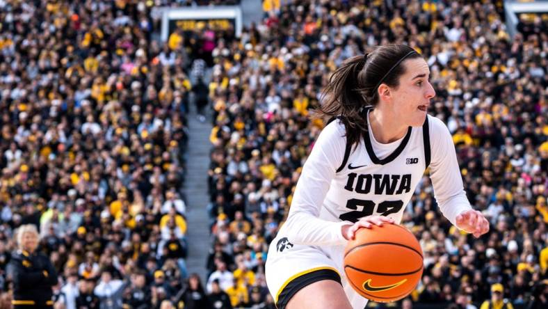 Iowa guard Caitlin Clark (22) drives to the basket during Crossover at Kinnick at Kinnick Stadium on Sunday, October 15, 2023 in Iowa City.