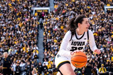 Iowa guard Caitlin Clark (22) drives to the basket during Crossover at Kinnick at Kinnick Stadium on Sunday, October 15, 2023 in Iowa City.