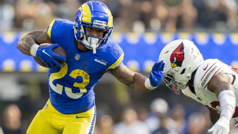 October 15, 2023; Inglewood, California, USA; Los Angeles Rams running back Kyren Williams (23) runs the football against Arizona Cardinals cornerback Marco Wilson (20) during the third quarter at SoFi Stadium. Mandatory Credit: Kyle Terada-USA TODAY Sports