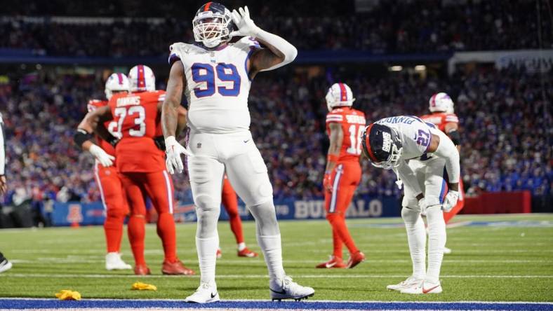 Oct 15, 2023; Orchard Park, New York, USA; New York Giants defensive end Leonard Williams (99) lets the crowd know he can   t hear them during the second half against the Buffalo Bills at Highmark Stadium. Mandatory Credit: Gregory Fisher-USA TODAY Sports