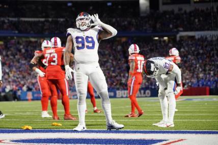 Oct 15, 2023; Orchard Park, New York, USA; New York Giants defensive end Leonard Williams (99) lets the crowd know he can   t hear them during the second half against the Buffalo Bills at Highmark Stadium. Mandatory Credit: Gregory Fisher-USA TODAY Sports