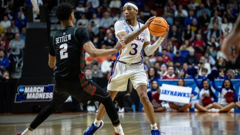 Kansas guard Dajuan Harris Jr. looks to make a pass against Howard during his team's first-round game in the 2023 NCAA men's tournament