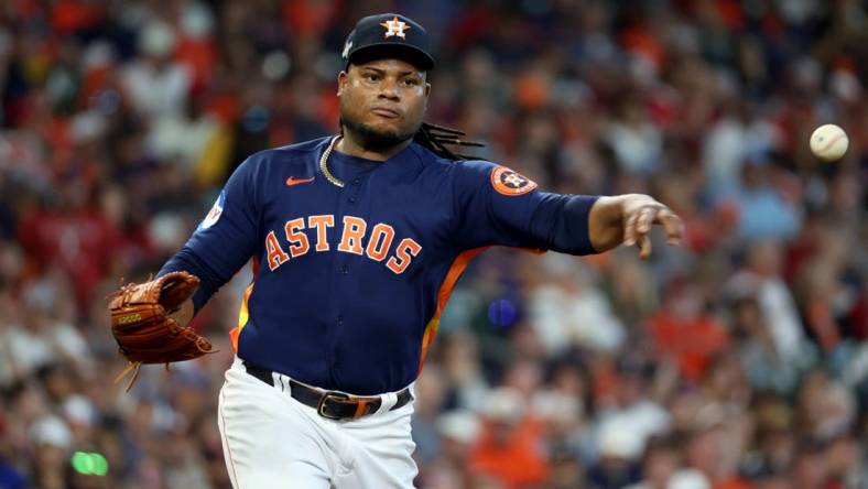 Oct 16, 2023; Houston, Texas, USA; Houston Astros starting pitcher Framber Valdez (59) throws to first base  in the second inning against the Texas Rangers during game two of the ALCS for the 2023 MLB playoffs at Minute Maid Park. Mandatory Credit: Thomas Shea-USA TODAY Sports