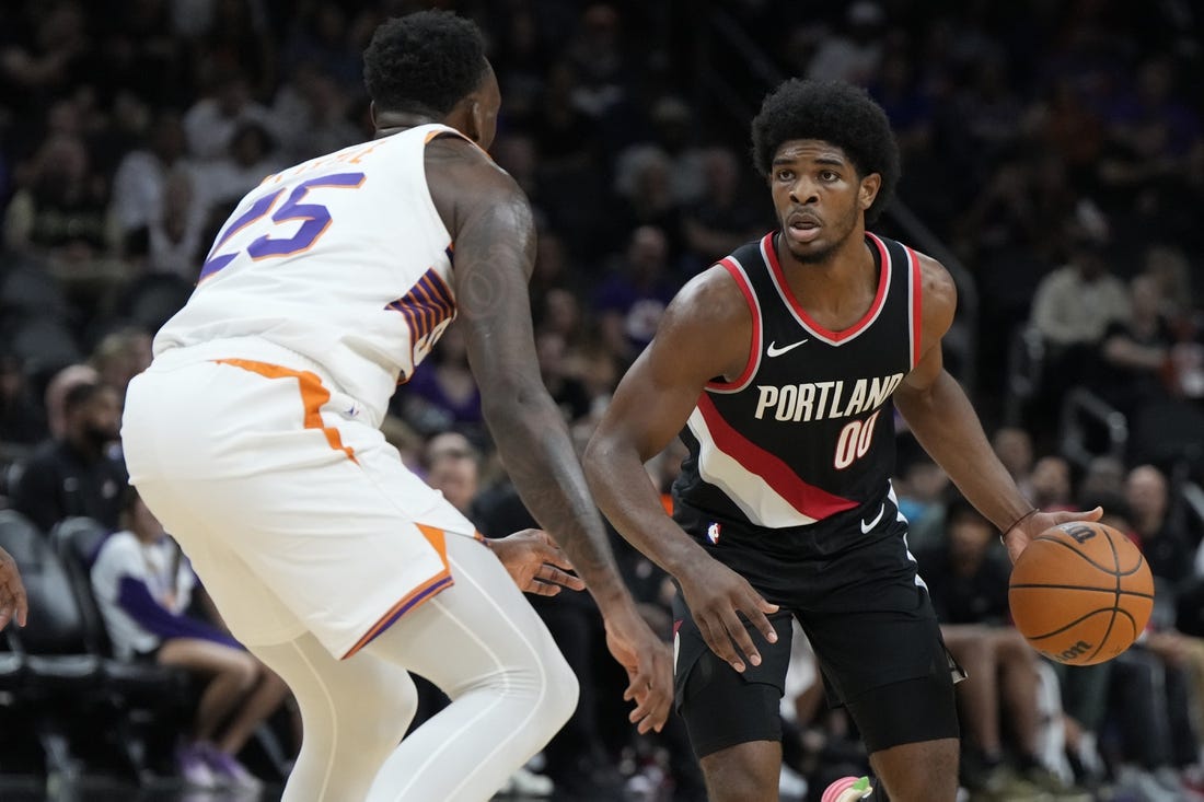 Oct 16, 2023; Phoenix, Arizona, USA; Portland Trail Blazers guard Scoot Henderson (00) drives past Phoenix Suns guard Nassir Little (25) in the second half at Footprint Center. Mandatory Credit: Rick Scuteri-USA TODAY Sports