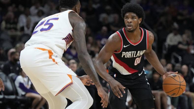 Oct 16, 2023; Phoenix, Arizona, USA; Portland Trail Blazers guard Scoot Henderson (00) drives past Phoenix Suns guard Nassir Little (25) in the second half at Footprint Center. Mandatory Credit: Rick Scuteri-USA TODAY Sports