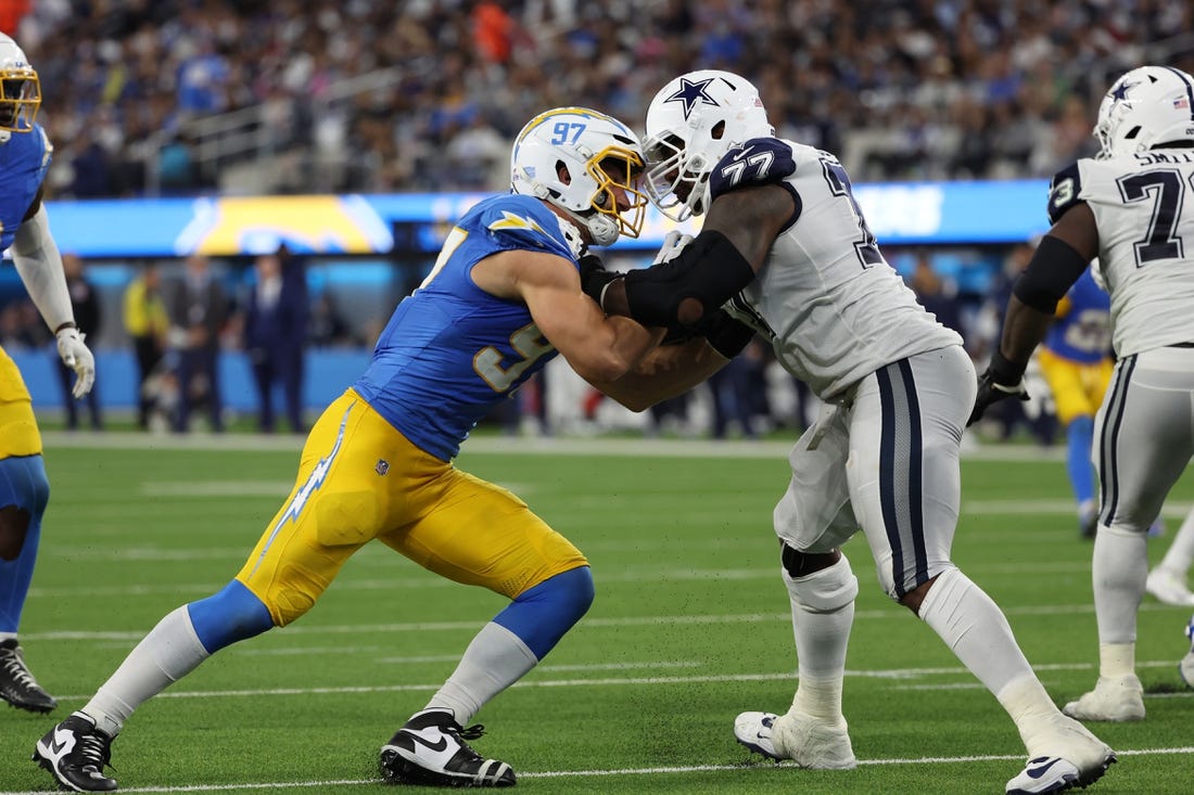 Oct 16, 2023; Inglewood, California, USA;  Los Angeles Chargers linebacker Joey Bosa (97) rushes against Dallas Cowboys offensive tackle Tyron Smith (77) during the third quarter at SoFi Stadium. Mandatory Credit: Kiyoshi Mio-USA TODAY Sports