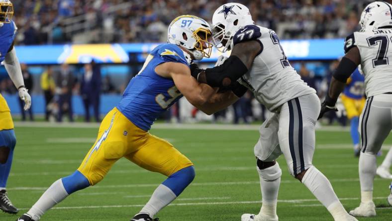 Oct 16, 2023; Inglewood, California, USA;  Los Angeles Chargers linebacker Joey Bosa (97) rushes against Dallas Cowboys offensive tackle Tyron Smith (77) during the third quarter at SoFi Stadium. Mandatory Credit: Kiyoshi Mio-USA TODAY Sports