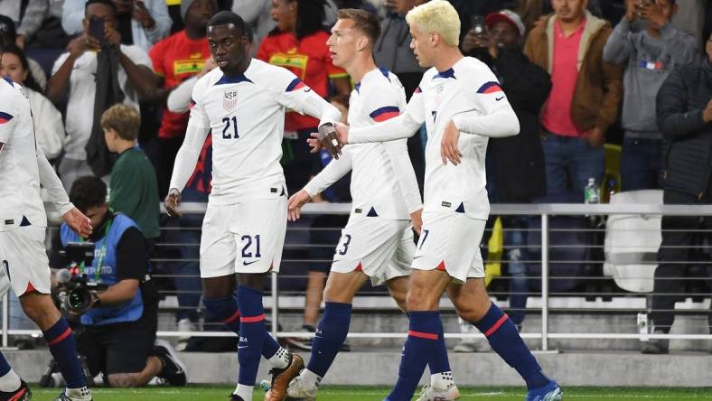 Oct 17, 2023; Nashville, Tennessee, USA; United States forward Tim Weah (21) celebrates with midfielder Gio Reyna (7) after a goal during the first half against Ghana at GEODIS Park. Mandatory Credit: Christopher Hanewinckel-USA TODAY Sports