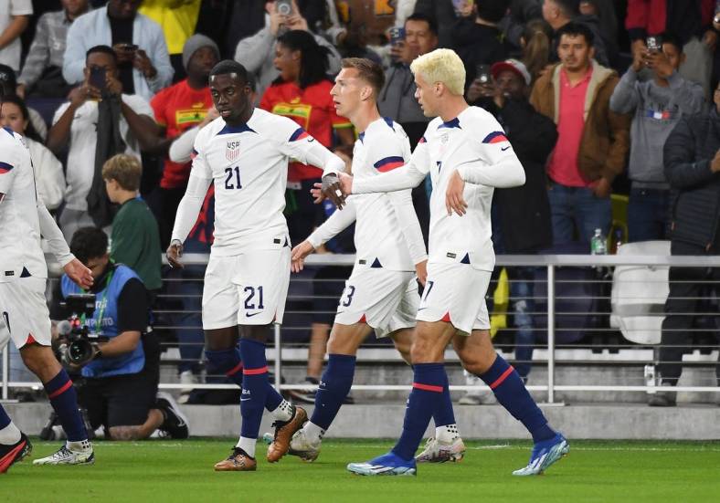 Oct 17, 2023; Nashville, Tennessee, USA; United States forward Tim Weah (21) celebrates with midfielder Gio Reyna (7) after a goal during the first half against Ghana at GEODIS Park. Mandatory Credit: Christopher Hanewinckel-USA TODAY Sports