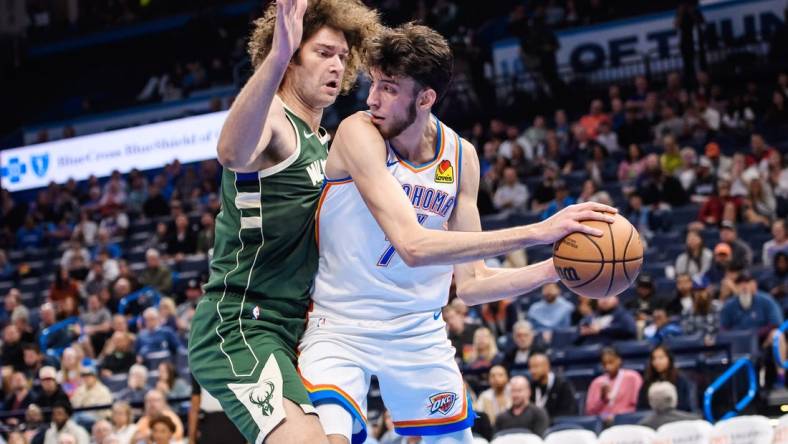 Oct 17, 2023; Oklahoma City, Oklahoma, USA; Oklahoma City Thunder forward Chet Holmgren (7) fights for position while defended by Milwaukee Bucks center Robin Lopez (42) during the first half at Paycom Center. Mandatory Credit: Rob Ferguson-USA TODAY Sports