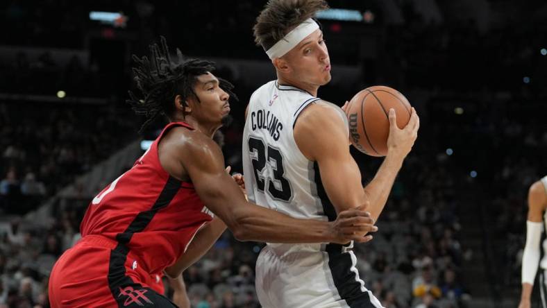 Oct 18, 2023; San Antonio, Texas, USA; San Antonio Spurs forward Zach Collins (23) spins around Houston Rockets forward Jermaine Samuels (00) in the first half at the Frost Bank Center. Mandatory Credit: Daniel Dunn-USA TODAY Sports