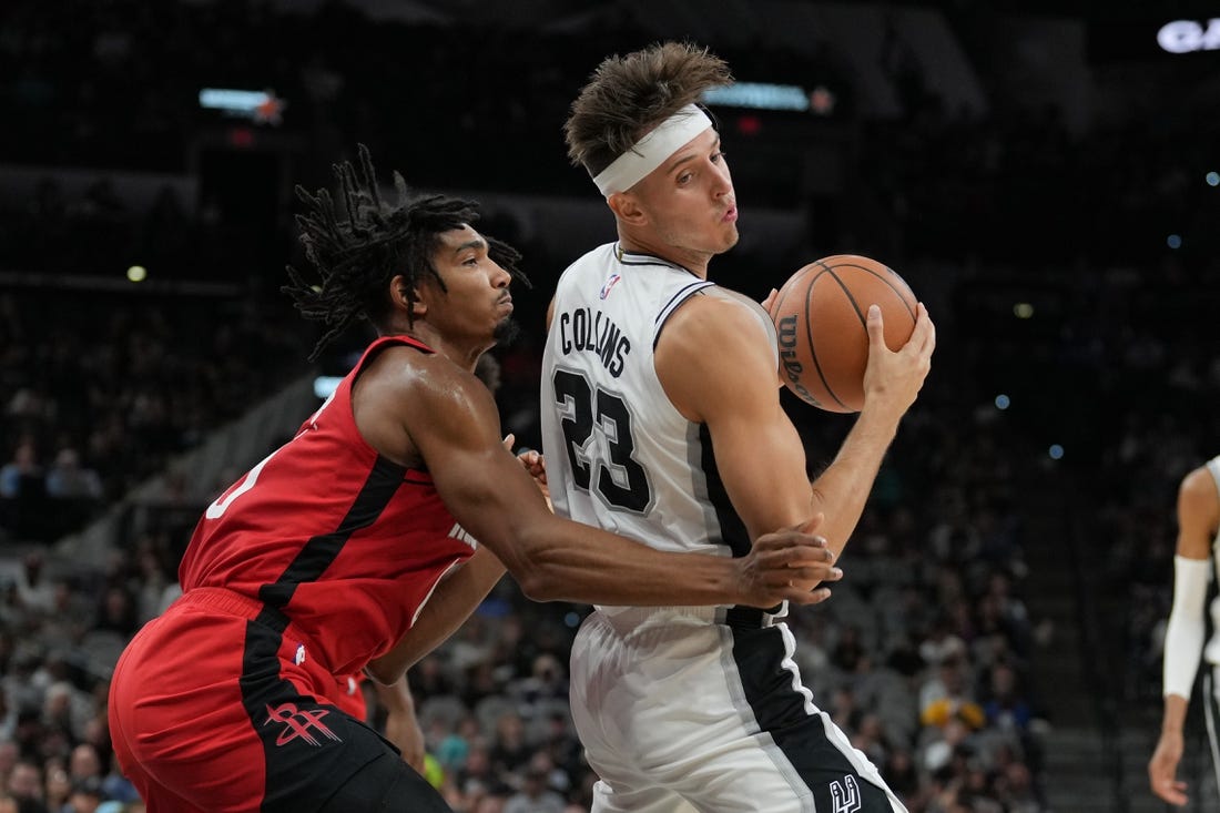 Oct 18, 2023; San Antonio, Texas, USA; San Antonio Spurs forward Zach Collins (23) spins around Houston Rockets forward Jermaine Samuels (00) in the first half at the Frost Bank Center. Mandatory Credit: Daniel Dunn-USA TODAY Sports
