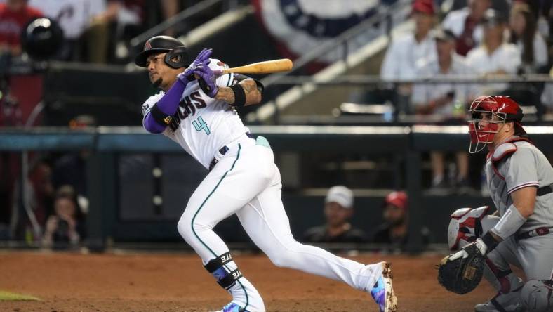 Arizona Diamondbacks second baseman Ketel Marte (4) hits double during the third inning against the Philadelphia Phillies in game three of the NLCS of the 2023 MLB playoffs at Chase Field in Phoenix on Oct. 19, 2023.